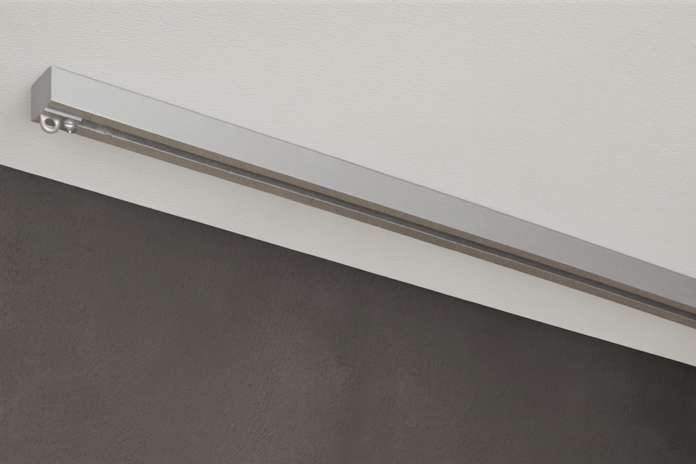 Alufarbene 1-läufige Aufputz-Gardinenschiene Modell 450 ohne Vorhang, verdeckt montiert an weißer Decke.